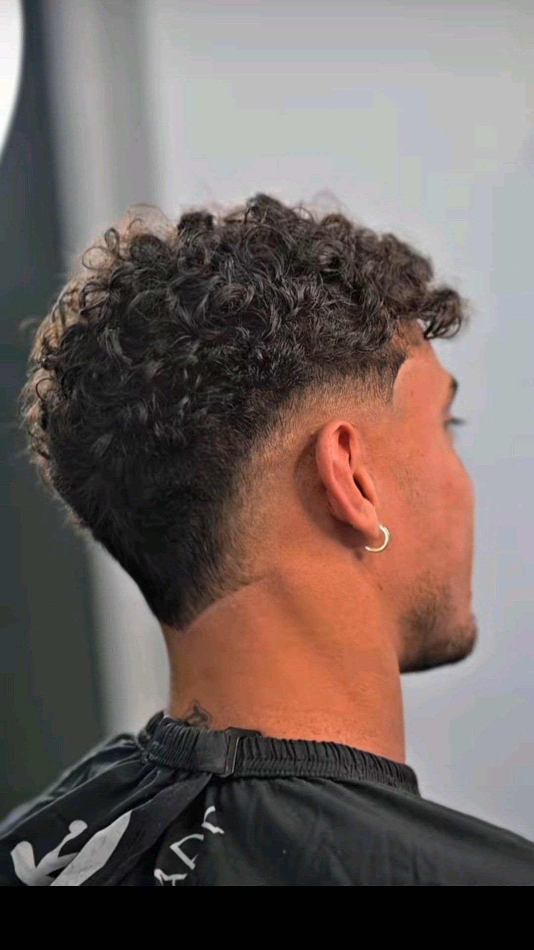 Barber performing a fade haircut